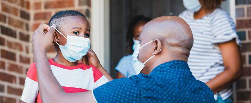 Parent Putting Mask On Kid